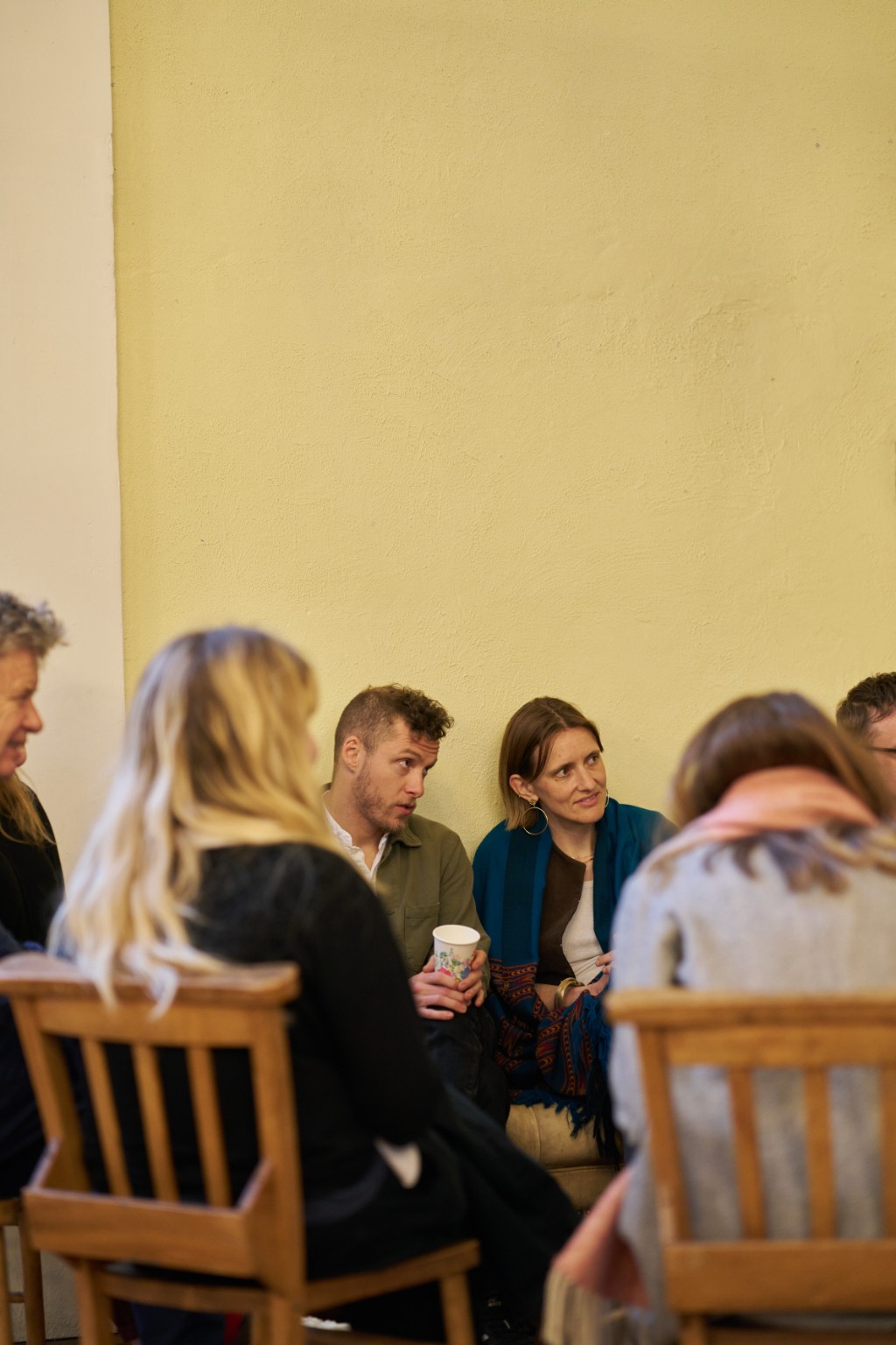 People listening and sharing ideas in a small group at Agora